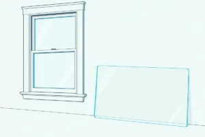 A clear acrylic sheet standing on its edge beside a single-pane sash window in a bright, plain room