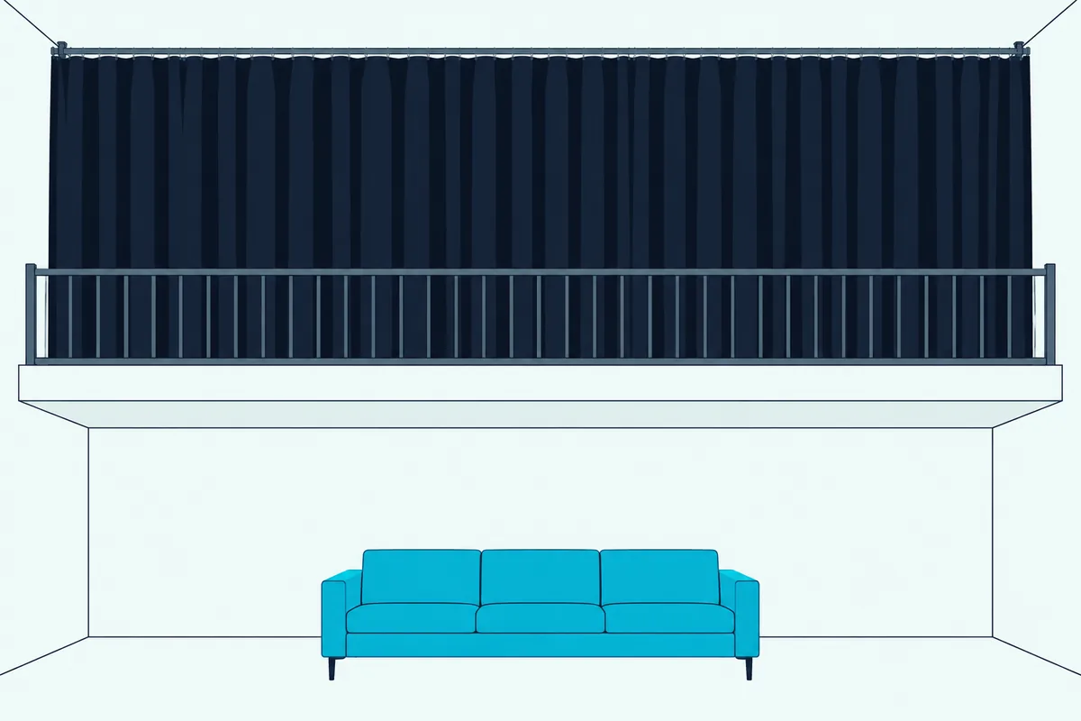 A heavy curtain on a ceiling track drawn across the railing of an open loft above a living room