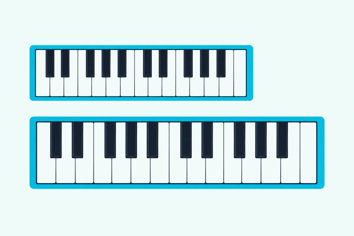 Two 25-key MIDI keyboards side by side on a desk, one with narrow mini keys and one longer with full-size piano keys