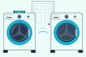 A washer and dryer side by side on rubber pads with a bubble level on the washer and a closed door behind them
