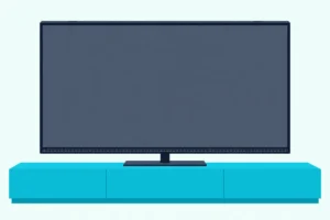 Flat TV with a blank screen and small built-in speakers in its frame, on a low console with no soundbar