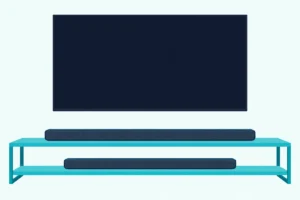 Longer and shorter dark soundbars on the two shelves of a low media unit under a wall-mounted TV with a blank screen