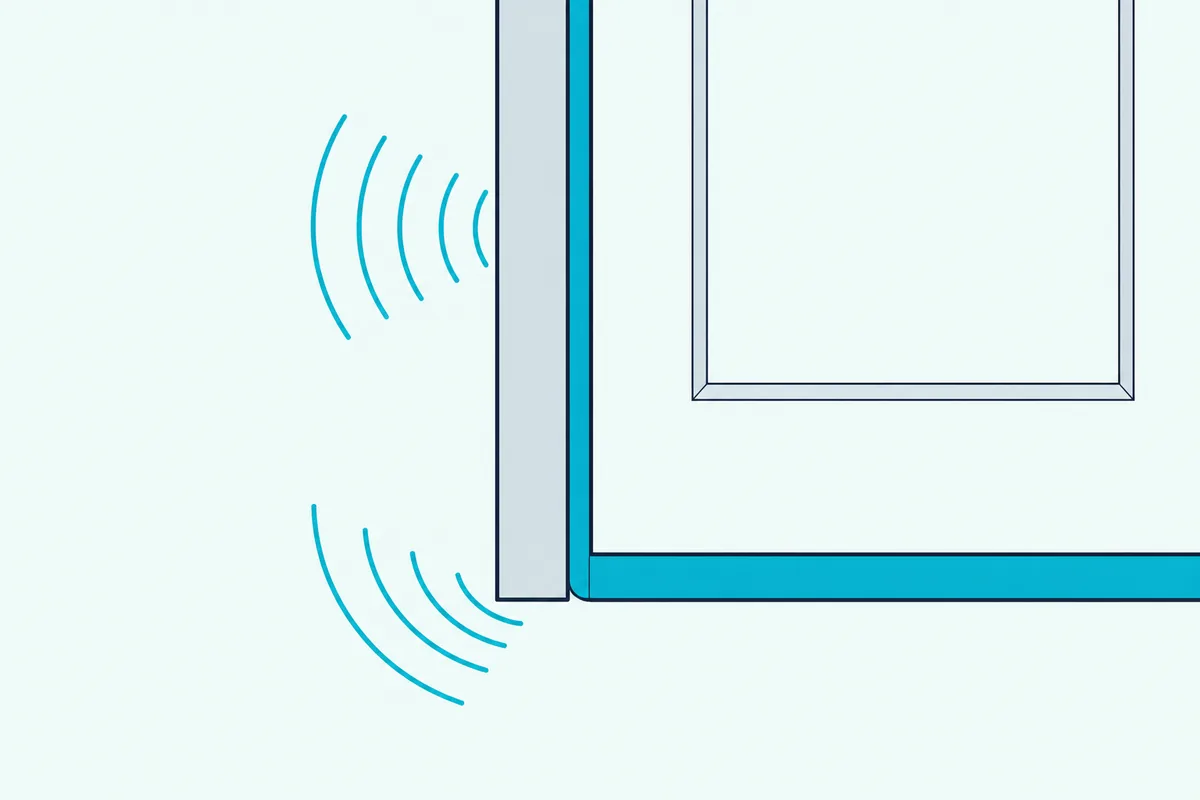 The lower corner of a shed door with a foam strip up the side and a seal along the bottom, sound waves stopping at both