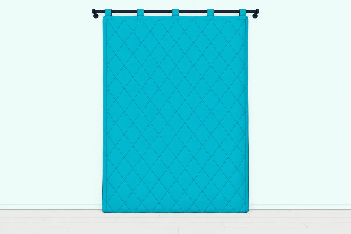 Quilted sound blanket hung over an interior bedroom door, overlapping the frame on every side