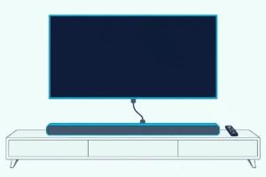 Slim soundbar below a wall-mounted TV, joined to it by one HDMI cable, with a TV remote on the console