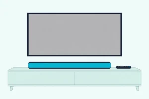 Soundbar on a wooden console under a TV with a blank screen, with a slim black remote control lying beside it