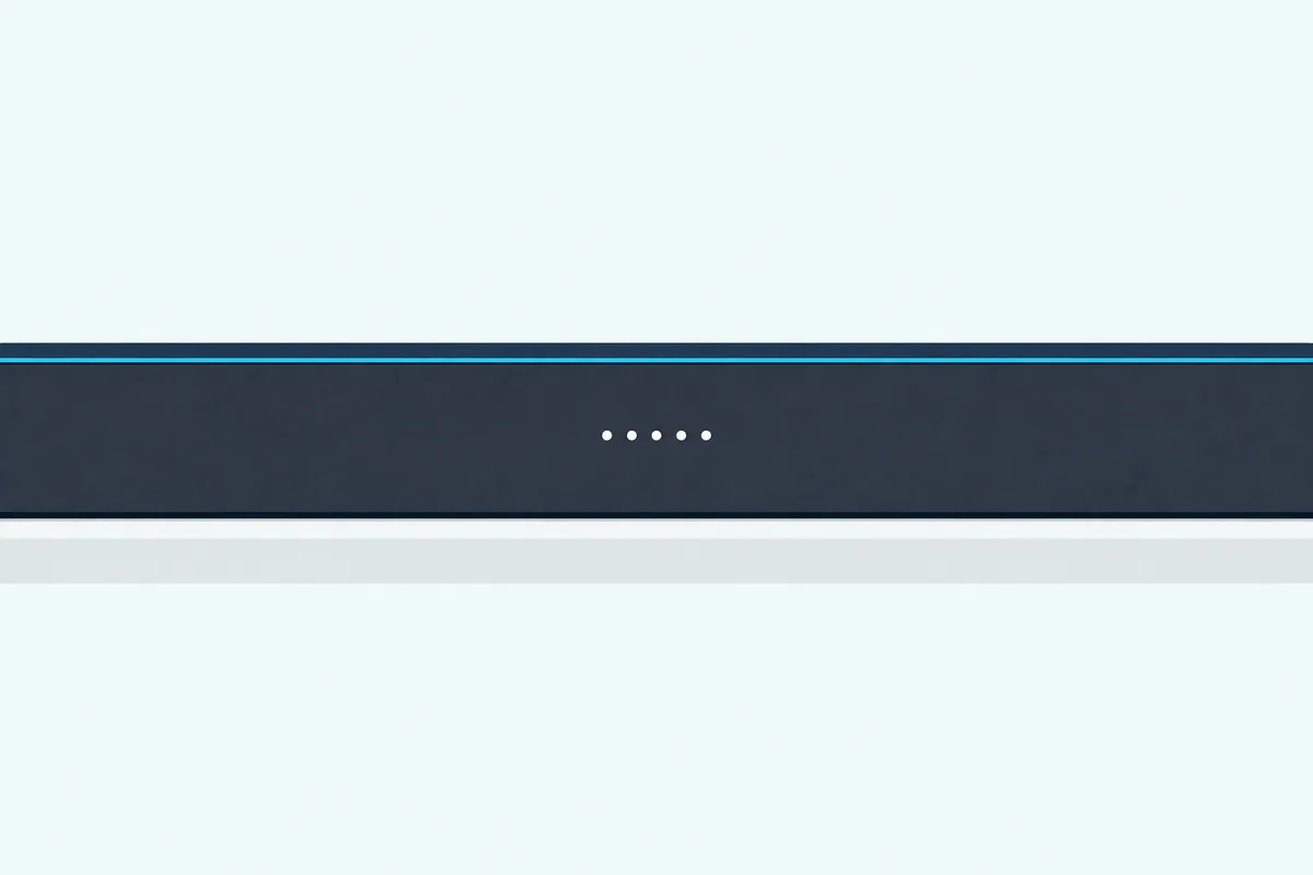 The front of a slim dark soundbar with a short row of small round lights glowing in the middle of its grille