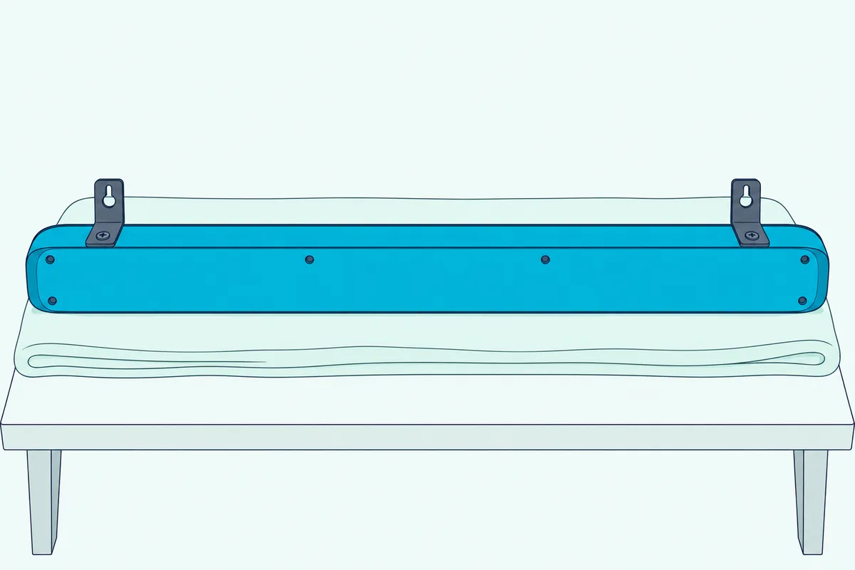 Underside of a slim soundbar resting upside down on a cloth, with small L-shaped metal brackets screwed near each end